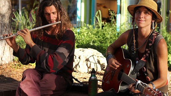 A couple jams out together on Pearl on a sunny afternoon in Boulder.