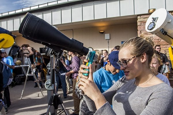 A lot of people took pictures with their phones through the binoculars and telescopes to capture the eclipse. (Photo: Joseph Wirth)