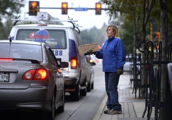 Photo Credit: Jeremy Papasso--Daily Camera. Renee McLaughin peacefully seeks financial assistance in Boulder
