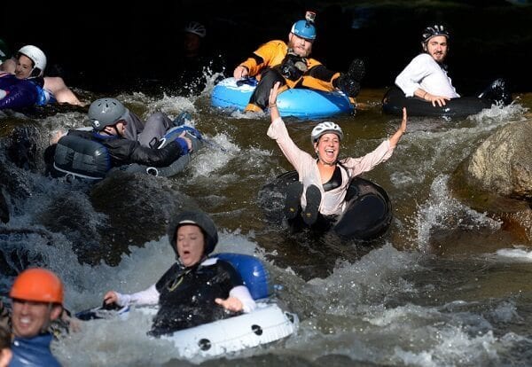 BOULDER, CO - JULY 14: Employees from Boulder's LogRhythm Inc. and others, don their professional attire and jump in to Boulder Creek on inner tubes and float to work on the company's "Tube to Work Day". (Photo by Kathryn Scott Osler/The Denver Post via Getty Images)