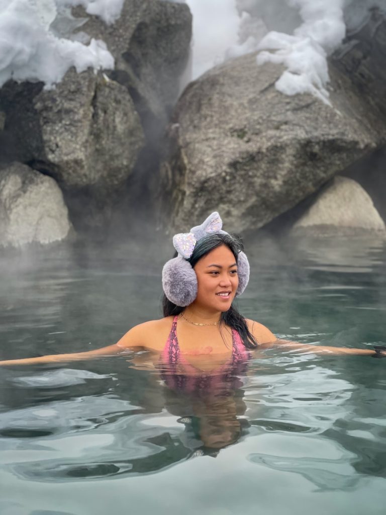 woman in pink bikini top on water during daytime