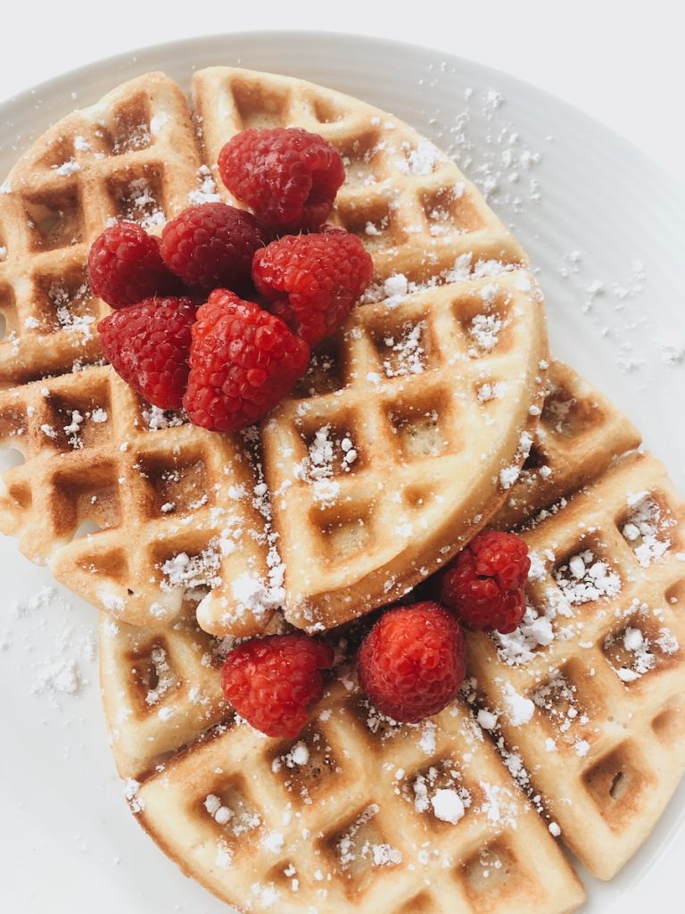 red strawberries on brown waffles