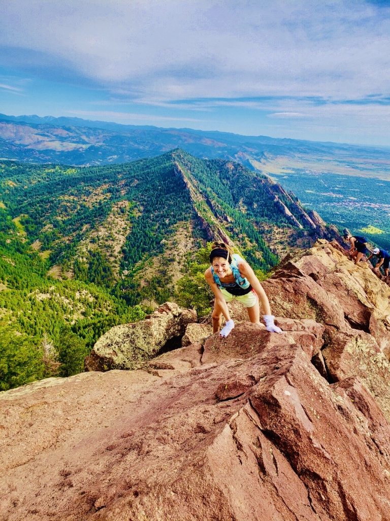 Brenna Bray scrambles atop Bear Peak while traversing the "Boulder Skyline" "out-and-back"