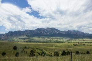 green grass field with mountains during daytime