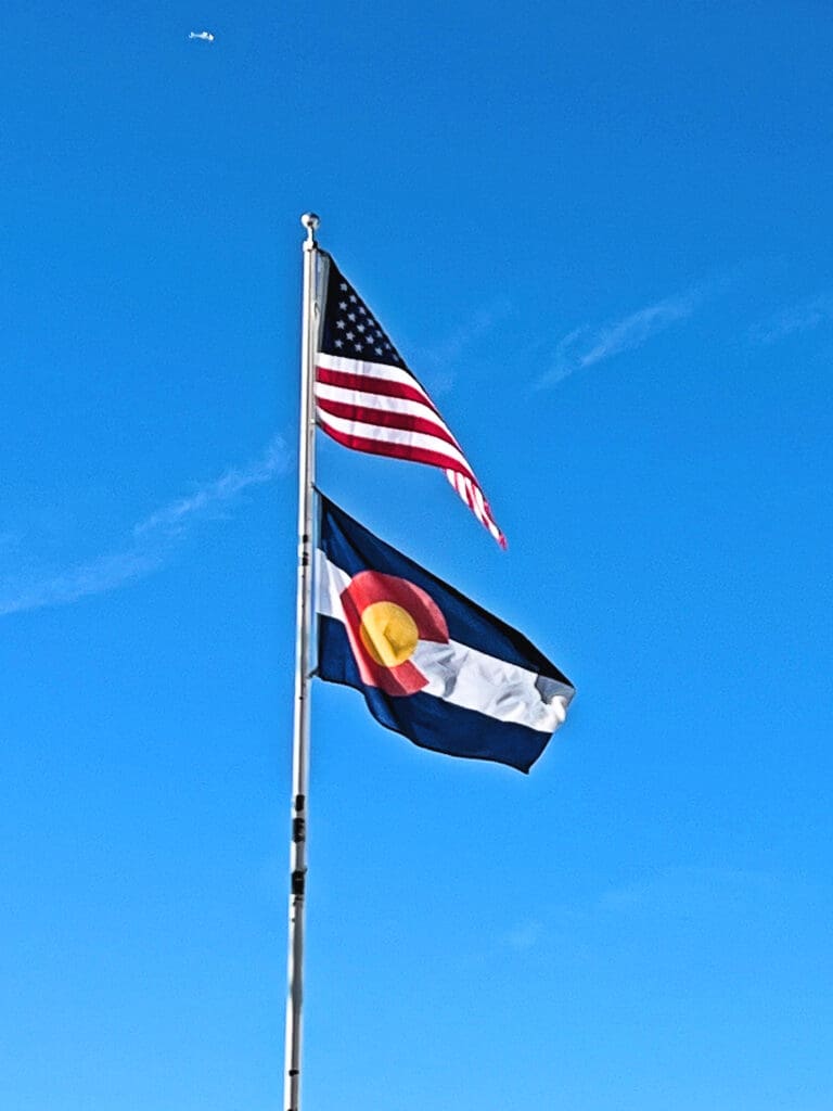 Boulder's Vets Day: The Day's History. US flag and Colorado flag