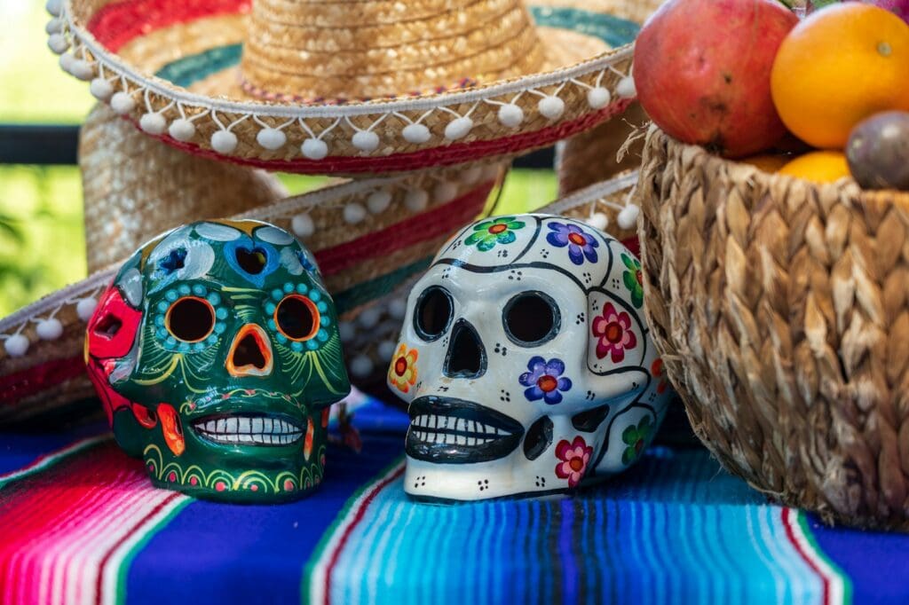 white and red ceramic skull figurine. Día de los Muertos: Day of the Dead