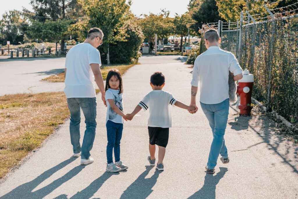 A family enjoying a sunny walk, showcasing diversity and love.