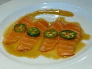 A large sushi try is getting a final prep review from manager Charlie