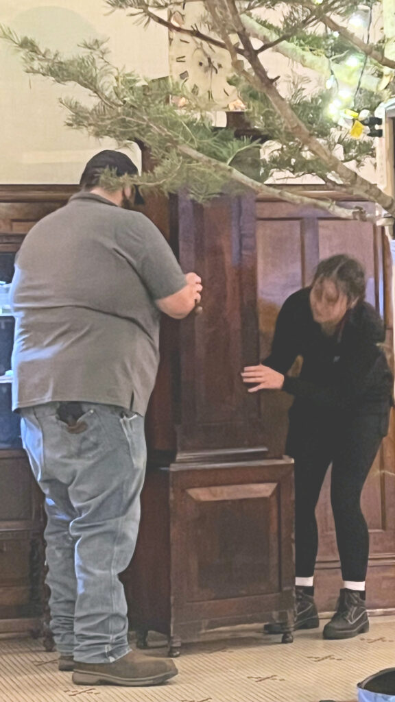 Lobby clock being re positioned.