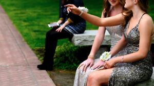 a woman in a sequin dress sitting on a bench
