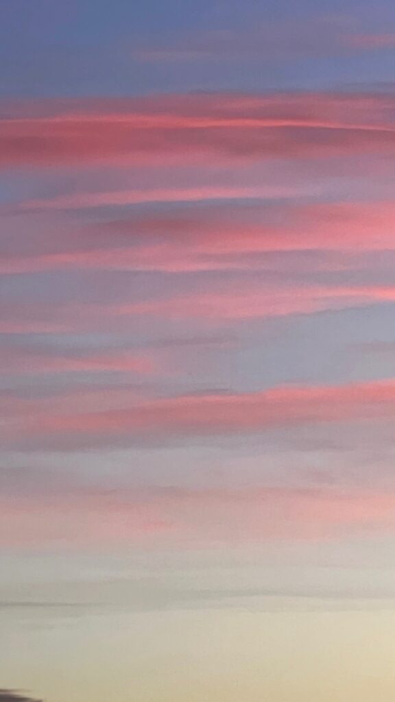light red bands of clouds over a blue sky