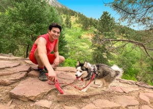 Reid Friedenberg hiking in the mountains with his puppy