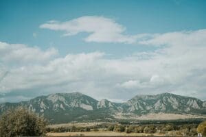 Beautiful landscape of the Flatirons in Boulder, Colorado under a blue sky.