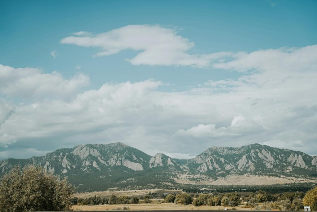 Beautiful landscape of the Flatirons in Boulder, Colorado under a blue sky.