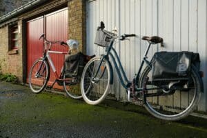 Two bicycles against a garage in Brugge, Belgium, showcasing urban lifestyle.
