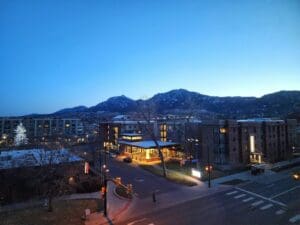 A view of a city at night with mountains in the background