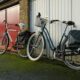 Two bicycles against a garage in Brugge, Belgium, showcasing urban lifestyle.