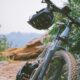 black mountain bike on brown field during daytime