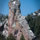 green pine trees on brown rocky mountain under blue sky during daytime