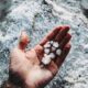 white stones on persons hand