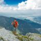 man standing on peak front of mountain at daytime